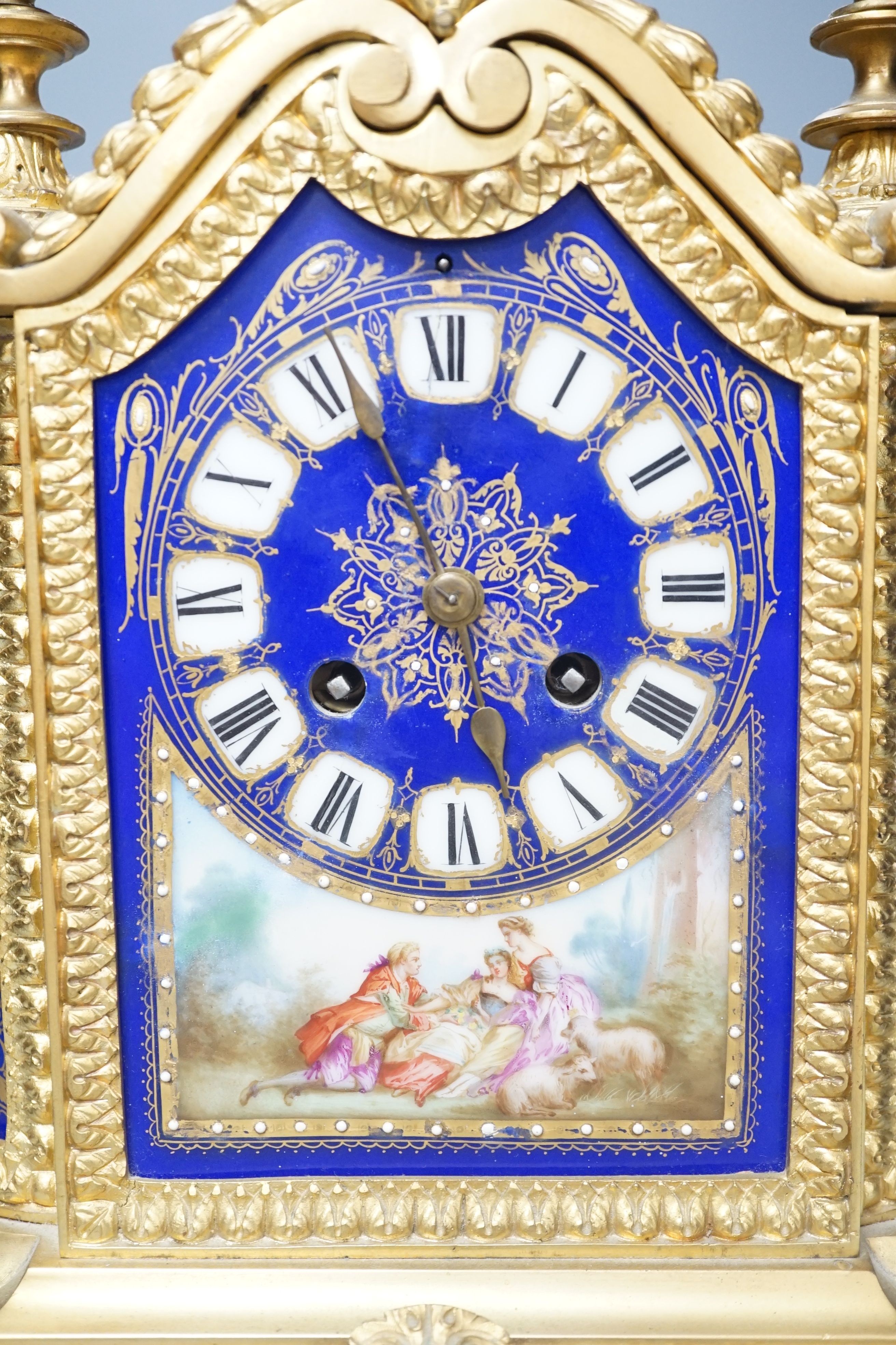 A 19th century French ormolu cased mantel clock, with decorated porcelain panels and face, eight day movement with strike, 40cm high